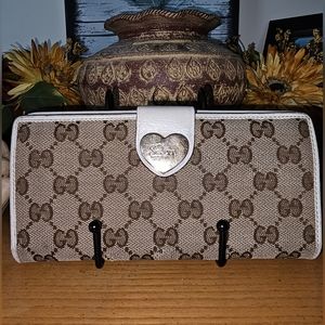 Gucci GG Monogram Long Wallet with Gucci stamped heart clasp.